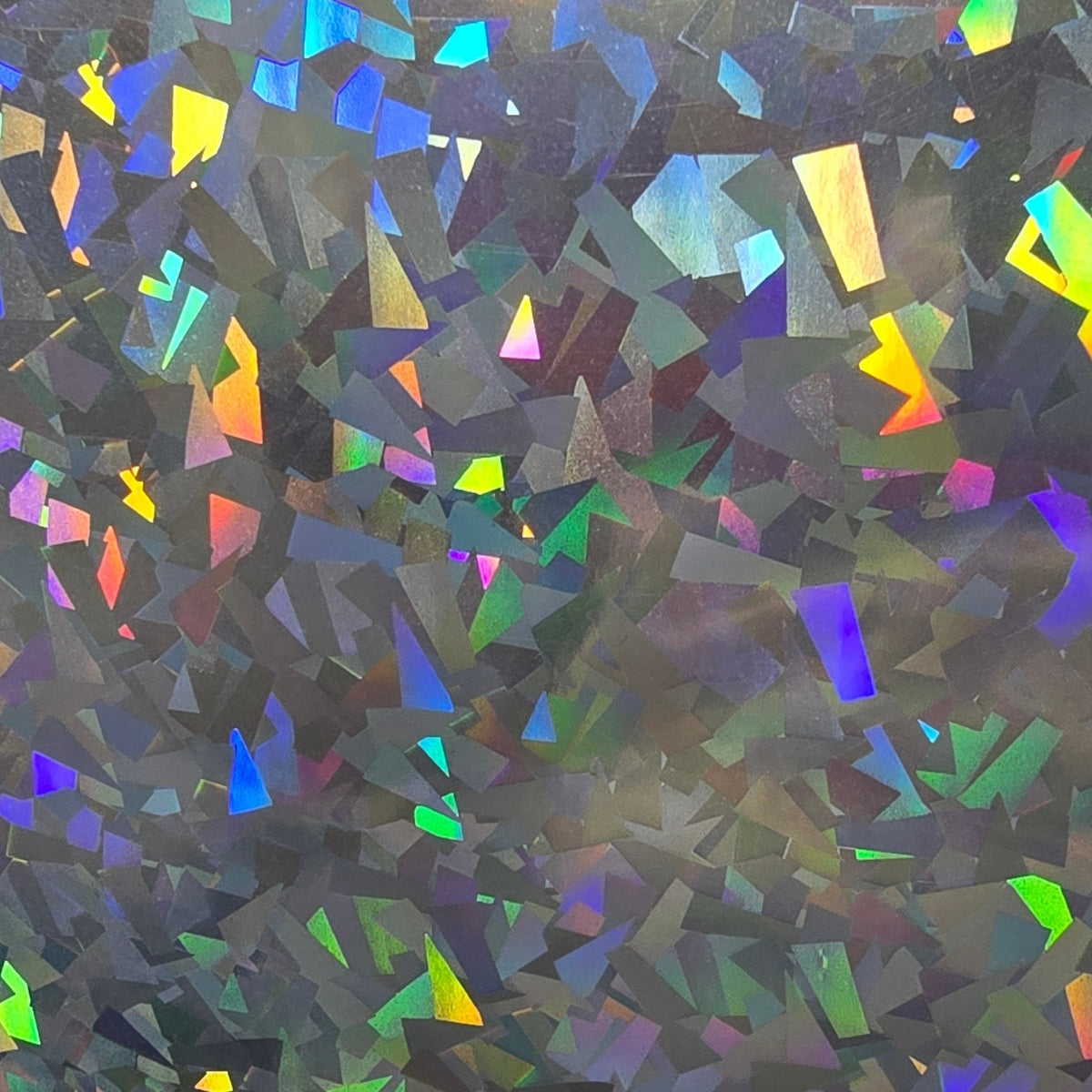 Smashed glass holographic vinyl with a rainbow spectrum finish and geometric, light-reflecting shards for signage.