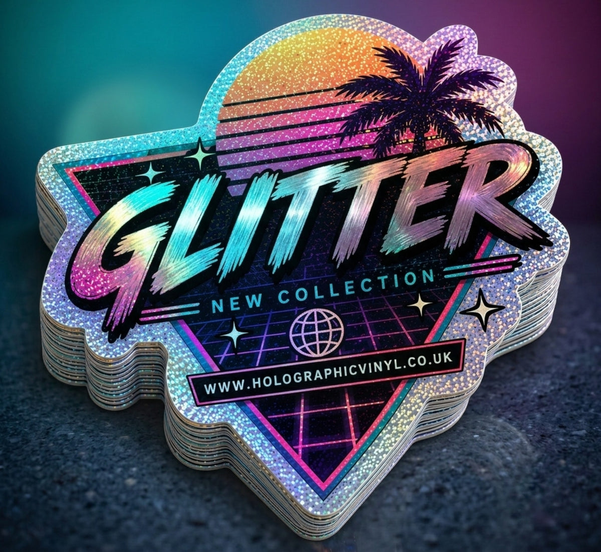 A stack of holographic stickers shaped like a retro sunset badge, featuring the word 'GLITTER' in large stylized letters, 'NEW COLLECTION' text, a palm tree silhouette, stars, and a website banner reading 'WWW.HOLOGRAPHICVINYL.